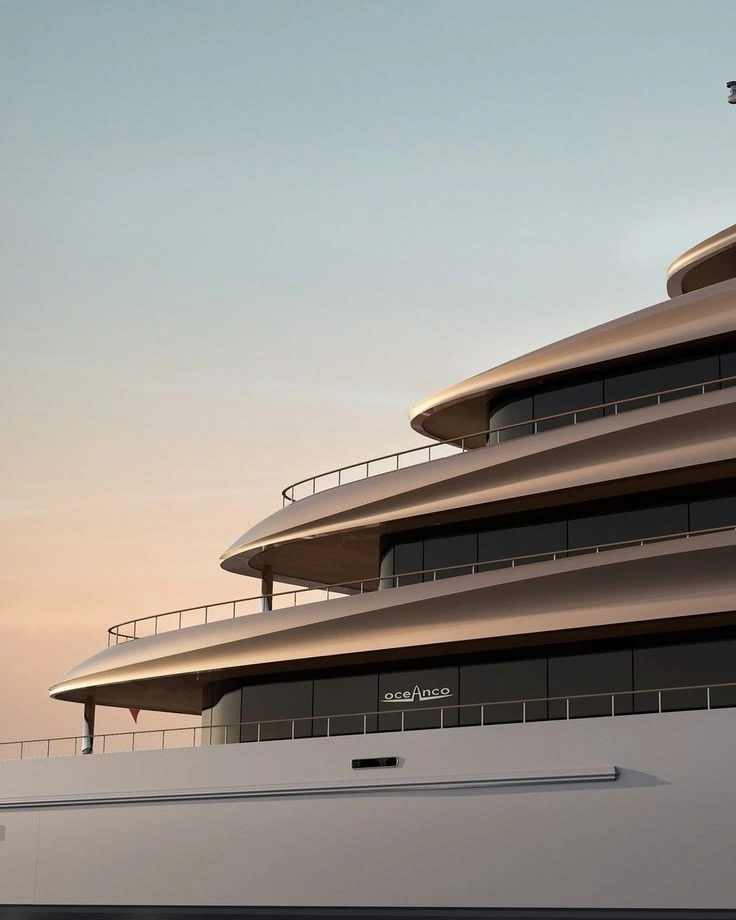 Sculpted superyacht decks and tinted glass against a soft sunset sky